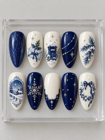 AI design mockup: Ten navy and ivory Christmas press-on nails with envelope, snowy mailbox, framed winter scene, blue wreath and silver-colour details.