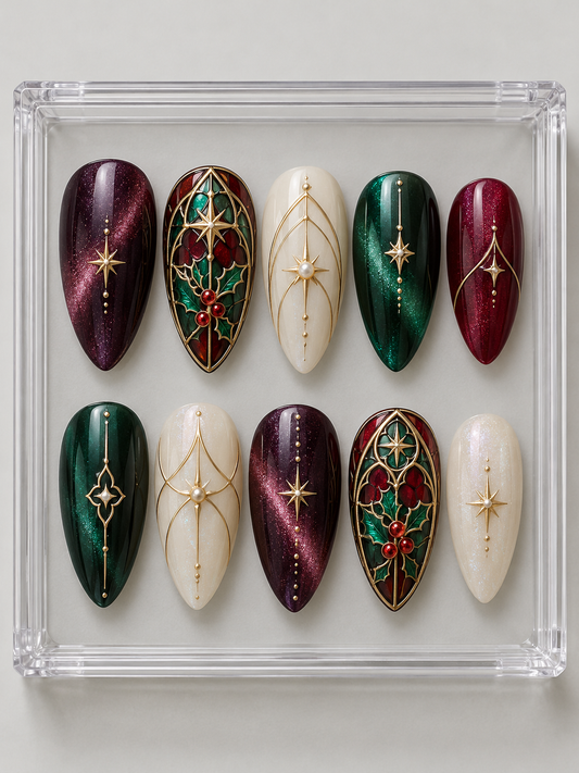 Ten emerald, plum, cranberry and ivory Christmas press-on nails with arched stained-glass-style holly panels, gold-colour tracery, stars and pearl-look accents.
