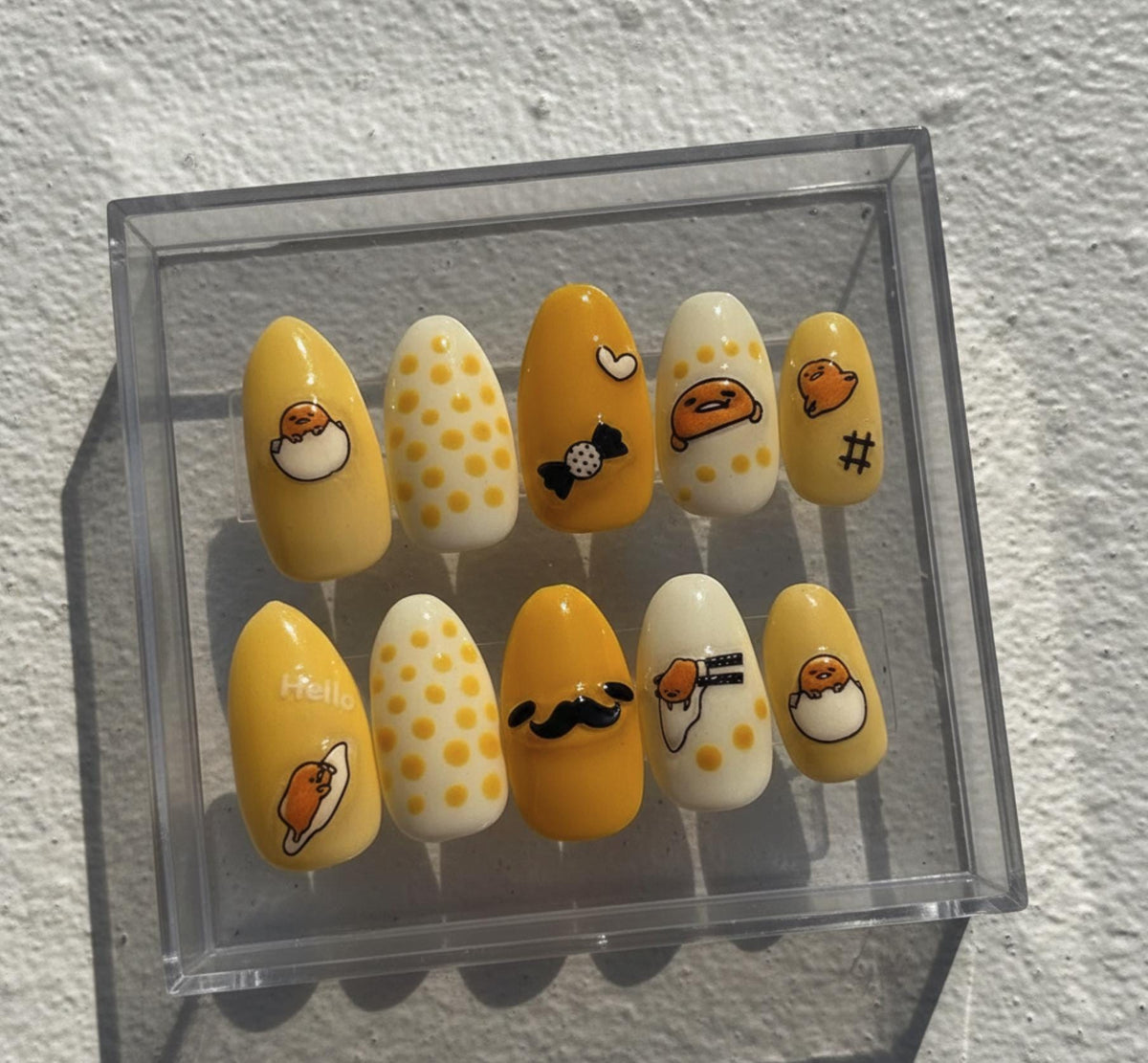 Gudetama press-on Nails; Yellow Sanrio Nails.