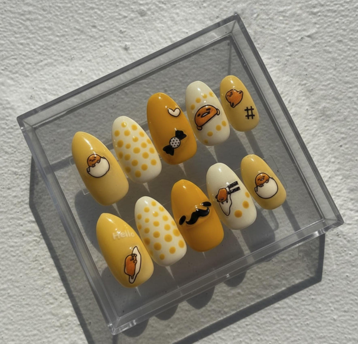 Gudetama press-on Nails; Yellow Sanrio Nails.