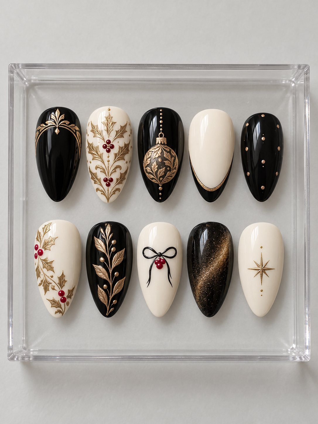 AI design mockup: Ten black and ivory Christmas press-on nails with bronze-gold-colour holly, patterned bauble, botanical branches and red berries.