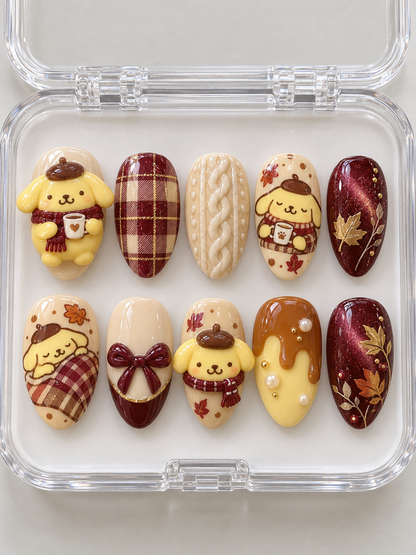 AI design preview: Pompompurin Fall Press-On Nails – Burgundy Sweater Weather; ten nails combining flat 2D character art and sculpted 3D gel details.