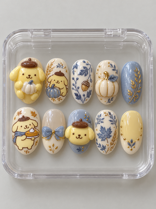 AI design preview: Pompompurin Thanksgiving Press-On Nails – Blue Porcelain Harvest; ten nails combining flat 2D character art and sculpted 3D gel details.