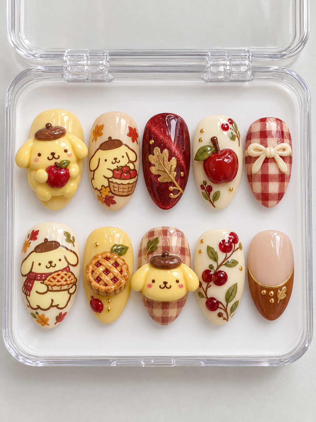 AI design preview: Pompompurin Thanksgiving Press-On Nails – Cranberry Apple Harvest; ten nails combining flat 2D character art and sculpted 3D gel details.