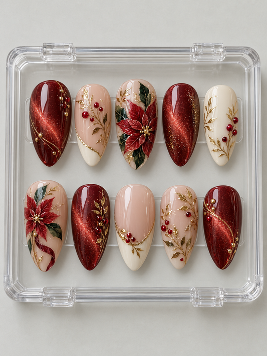 Ten ruby-red, nude and ivory Christmas press-on nails with poinsettia flowers, green leaves, red berries, gold-colour branches and French-style tips.