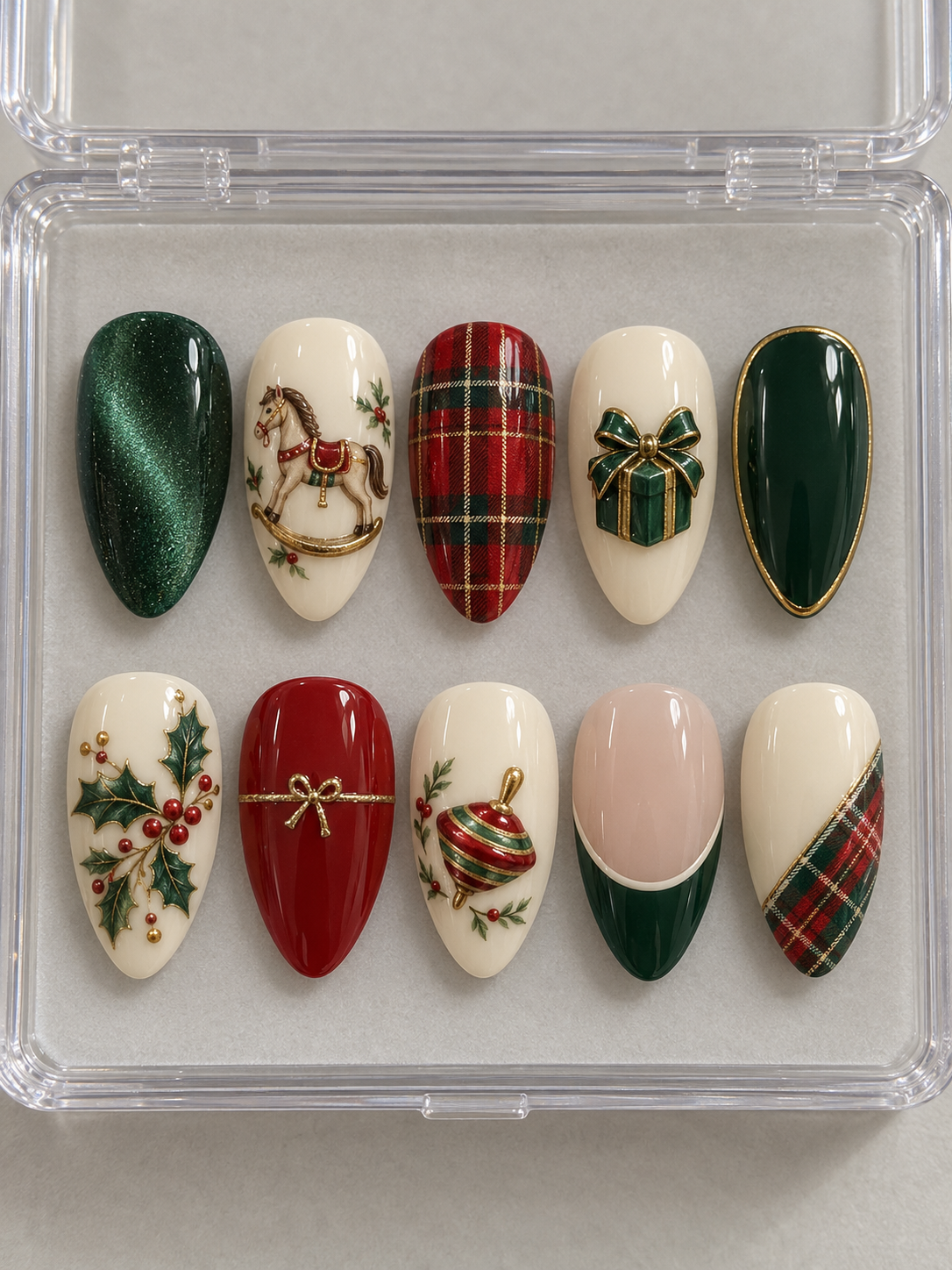 AI design mockup: Ten emerald, red and cream Christmas press-on nails with rocking horse, tartan, gift box, spinning top, holly and green French tip.